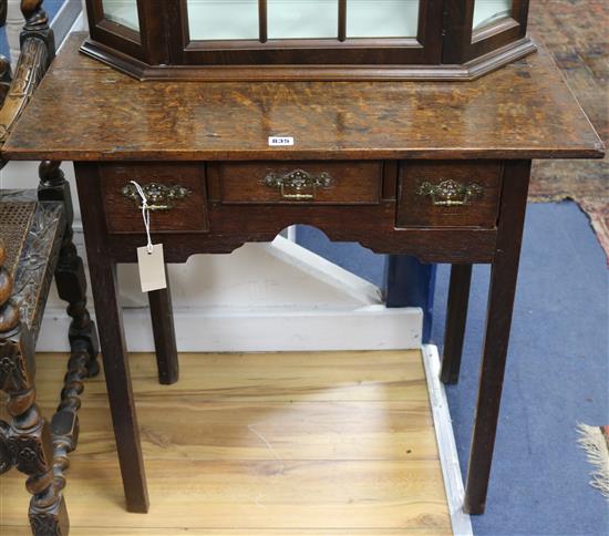 A Georgian oak side table, fitted three drawers, on square chamfered legs, W.77cm